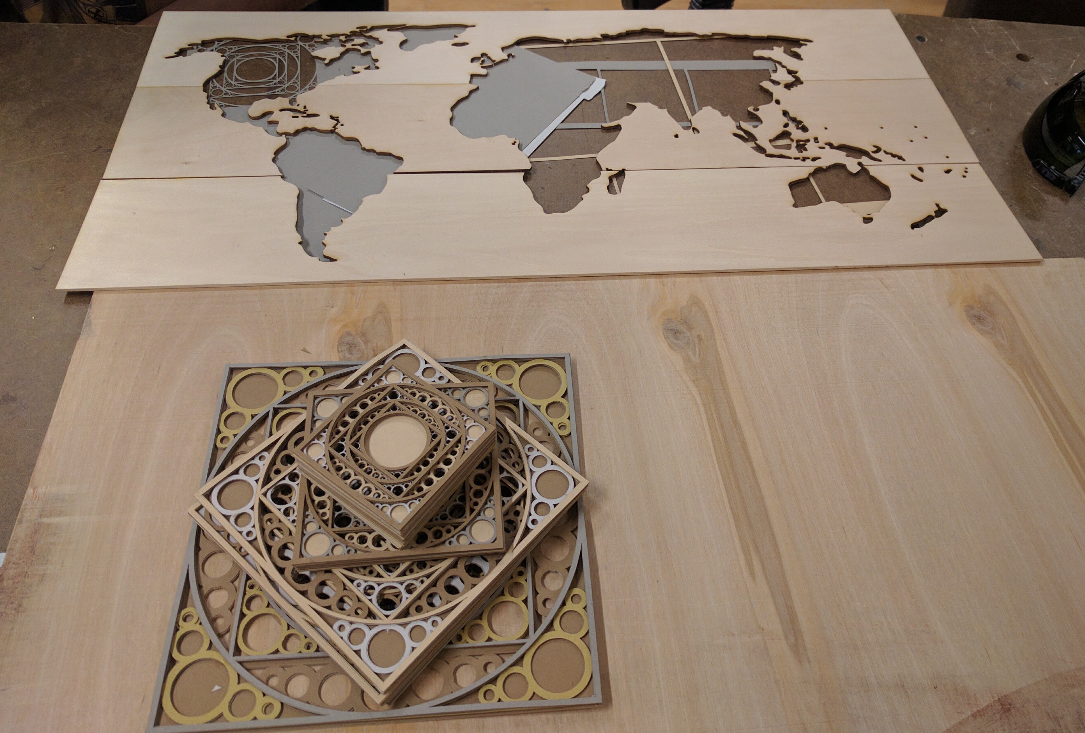 bass wood with world map cut out and laser cut paper